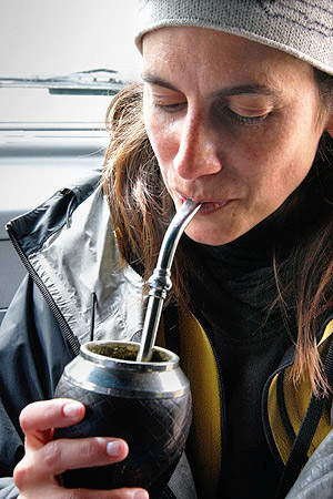 Girl drinking a tea mate, Patagonia, Argentina, Chile